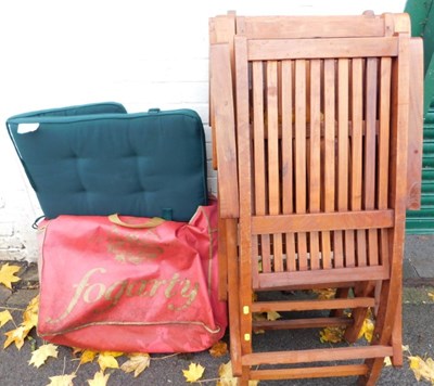 Lot 1077 - Three teak slatted seat and back folding...