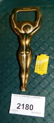 Lot 2180 - A brass bottle opener in the form of a naked...
