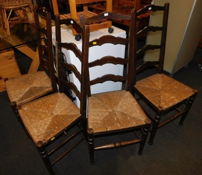 Lot 1046a - A set of four oak framed ladder back chairs,...