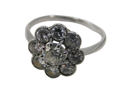 Lot 6 - A diamond cluster ring, the central round...